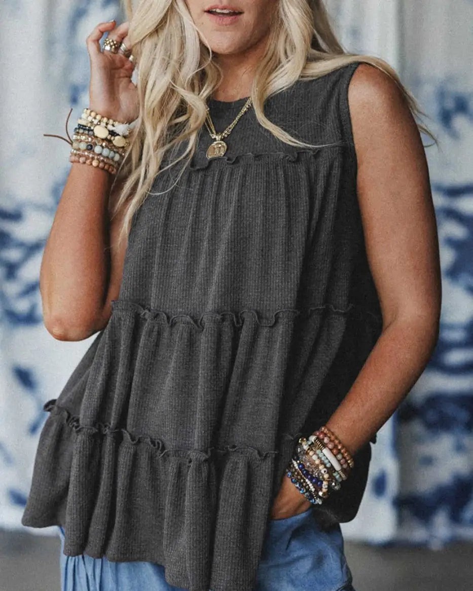 Your summer wardrobe just got the effortless upgrade it deserves.

This dark grey tiered frill tank top combines softly feminine frills with a relaxed, flowing fit that works for everything from casual coffee runs to weekend adventures. The lightweight blend keeps you cool while the high-stretch fabric moves with you all day long.

#SummerStyle #CasualTop #FrillTankTop #EffortlessStyle #WarmWeatherEssential